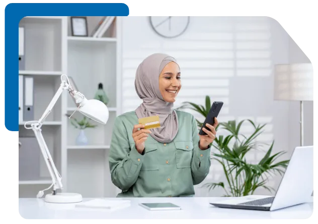 muslim woman happily entering her bank card credentials onto her smartphone