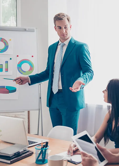 man presenting data to his coworkers