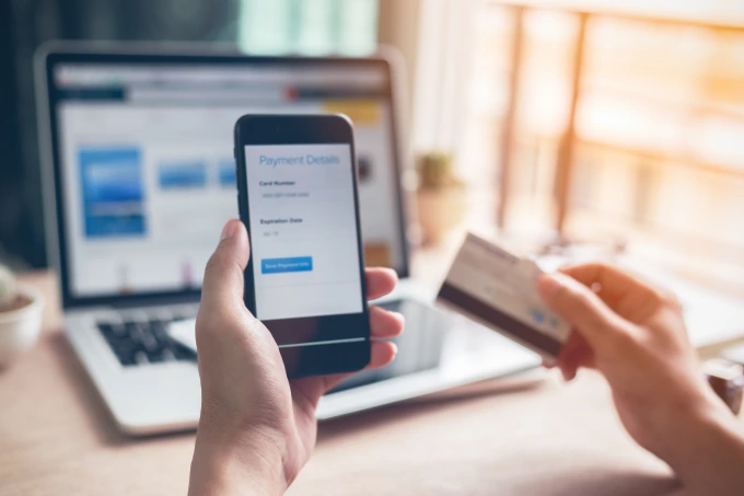 a man in the final stage of completing an online payment on his mobile phone