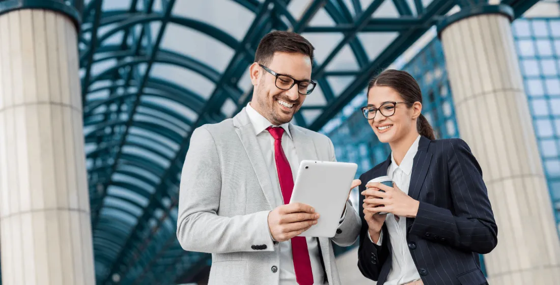 two work colleagues looking at the screen of their ipad