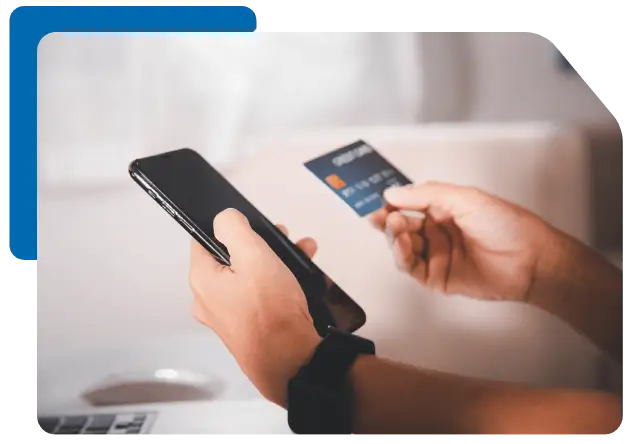 a man making an online payment using his payment card and mobile phone